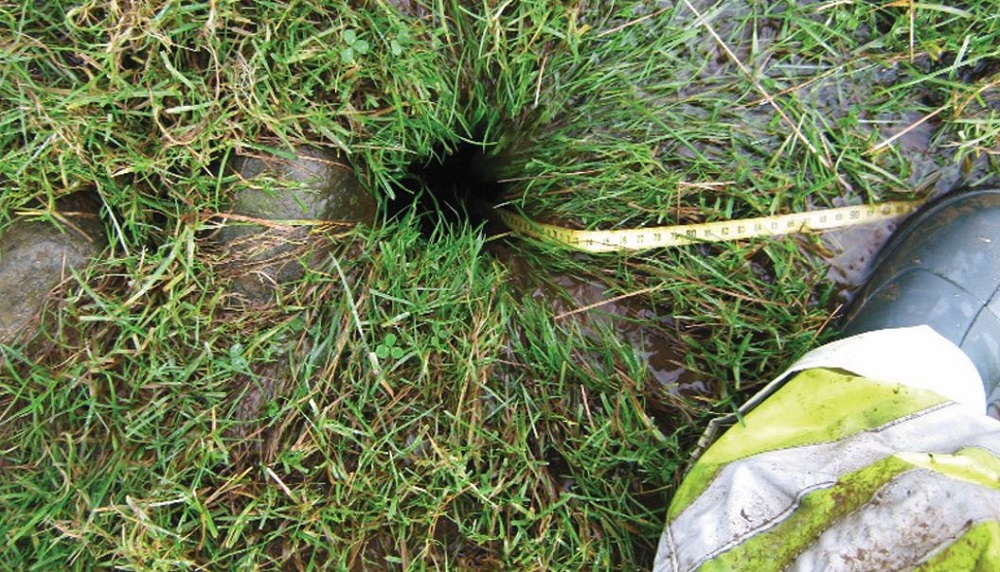 A field drain 'blow hole' with water pouring in
